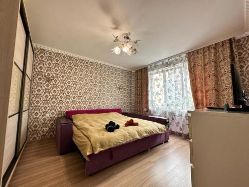 a bedroom with a bed with two teddy bears on it at LUZ @ Chisinau in Chişinău