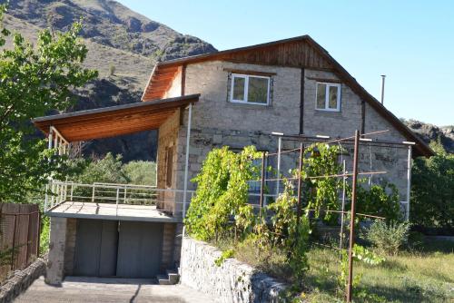 a house with a bunch of vines in front of it at Guesthouse Aleksastan in Aspindza