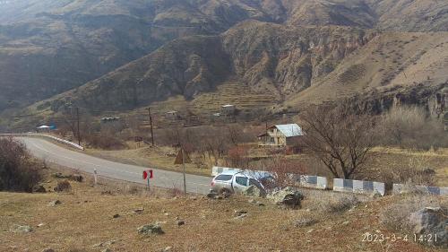 a white van parked on the side of a road at Guesthouse Aleksastan in Aspindza