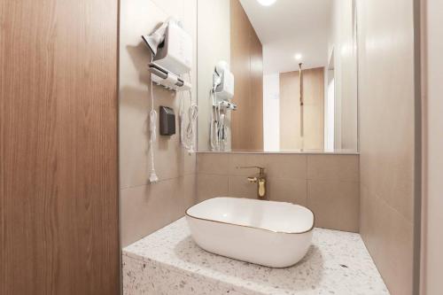 a bathroom with a white tub sitting on a counter at Wonju Brown Dot Hotel Corporate Business in Wonju