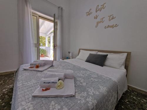 a bedroom with a bed with two towels on it at Meraviglia d'Otranto in Otranto