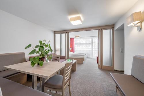 a living room with a table and a dining room at all inclusive Hotel Lohmann in Obergurgl