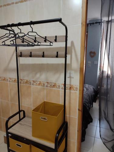 a metal bunk bed with a yellow box on it at Chambre d hote in Bonnétable