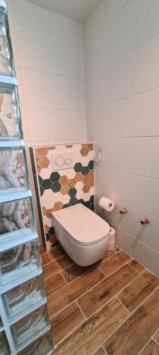 a bathroom with a toilet sitting on a wooden floor at Grund in Ólafsvík in Ólafsvík