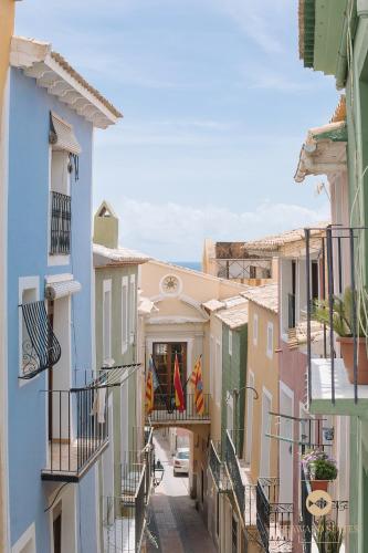 an alley in a town with colorful buildings at Castelar Palace & SPA by Seaward Suites in Villajoyosa