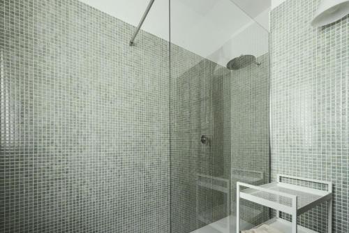 a bathroom with a glass shower with a sink at il larice d' oro in Sueglio