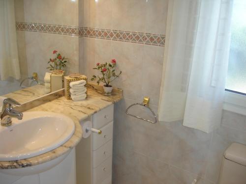 a white bathroom with a sink and a shower at Viva La Vida ! - Cristall Beach Villa in Miami Platja