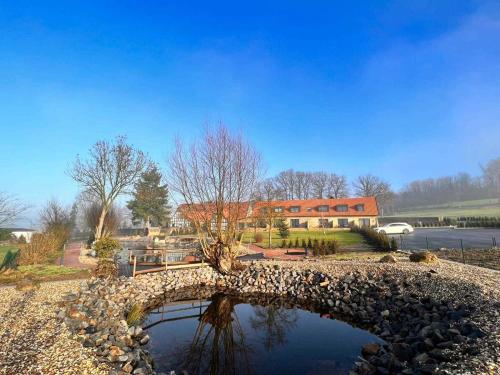 a stone bridge over a pond in front of a building at DRIEHOF LifeStyle Comfort Apt 4 in Tecklenburg