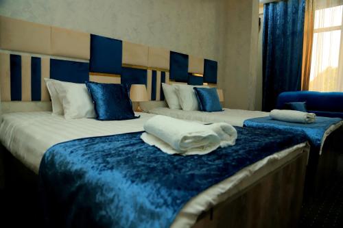 Ein Bett oder Betten in einem Zimmer der Unterkunft Green Hotel Dushanbe
