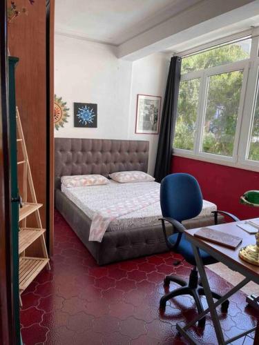 a bedroom with a bed and a desk and a chair at Casa sul mare in Porto Torres