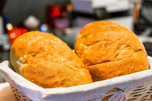 two loaves of bread sitting in a basket at Penzión Ľadoveň SKVELÁ KUCHYŇA A RODINNÁ ATMOSFÉRA in Martin
