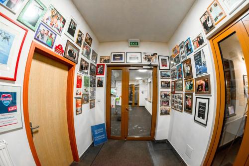 a hallway with pictures on the walls at Penzión Ľadoveň SKVELÁ KUCHYŇA A RODINNÁ ATMOSFÉRA in Martin