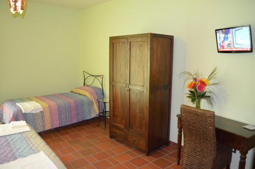 a bedroom with a bed and a wooden cabinet and a desk at B&B La casa di Giulietta in Castelmezzano