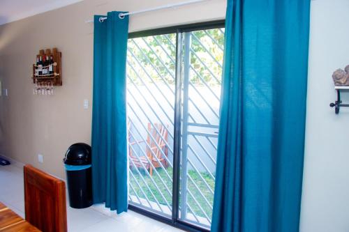 a room with a window with blue curtains at Home@Amalia’s in Rundu