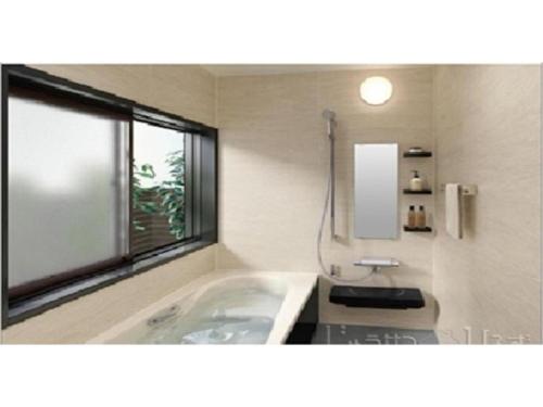 a bathroom with a bath tub and a window at 2-10-15 Imagawa - Apartment / Vacation STAY 7905 in Tokyo