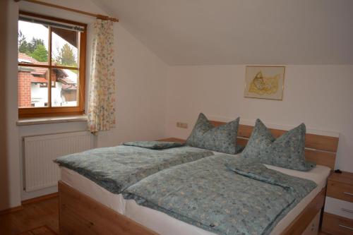 1 dormitorio con cama y ventana en Haus letzte Rose en Rieden am Forggensee