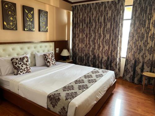 Ένα ή περισσότερα κρεβάτια σε δωμάτιο στο Malaysia Hotel Bangkok