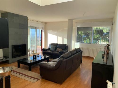 a living room with a couch and a table at Villa Gloria in Los López