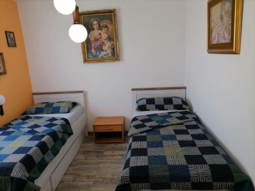 a bedroom with two beds and a picture on the wall at Bolf in Novigrad Istria