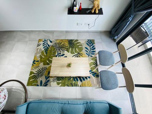a living room with a table and chairs at Proboscis Guest House Monthly in Sandakan