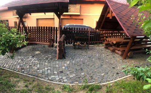 a statue of a dog sitting in front of a house at Катерина in Chynadiyovo