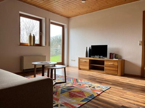 a living room with a couch and a tv at Ferienwohnung Antonie in Tettnang