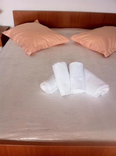 two rolls of toilet paper on a bed at Apartments Juric in Baška Voda