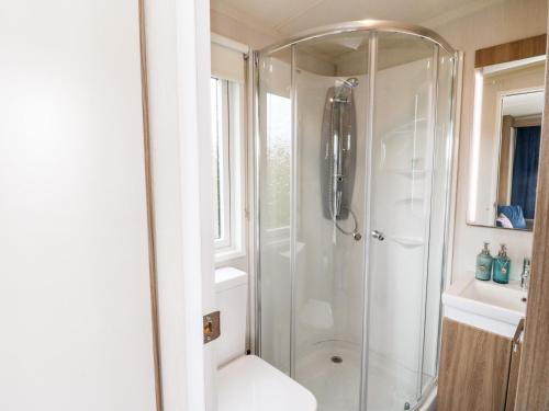 a bathroom with a shower with a toilet and a sink at Balvicar Beag in Oban