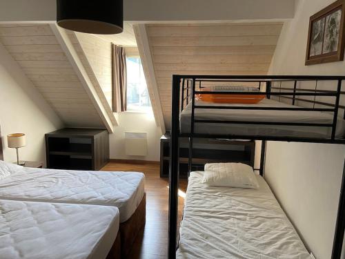 two bunk beds in a room with a staircase at Duplex 10 personnes in Saint-Lary-Soulan