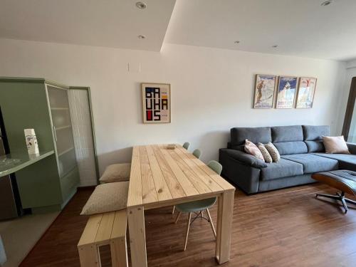 a living room with a table and a couch at Javalambre Mountain Superski in Camarena de la Sierra