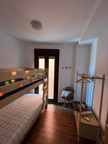a bedroom with a bunk bed and a staircase in it at Javalambre Mountain Superski in Camarena de la Sierra