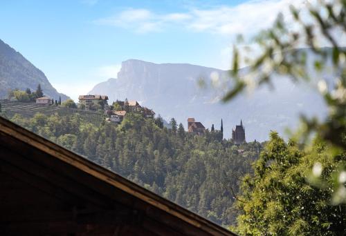 a view of a mountain with a town on a hill at Alivo Living Apartment Aurora in Rifiano