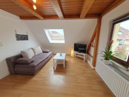 a living room with a couch and a table at Gemütliche zentrale DG Wohnung in Mühlacker in Mühlacker