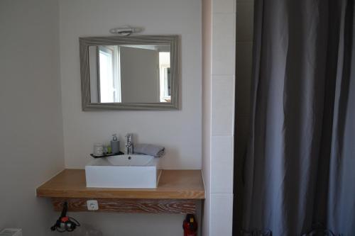 a bathroom with a sink and a mirror at Strandhof Holnis in Glücksburg