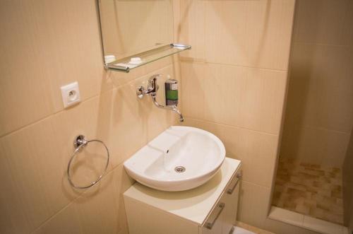 a bathroom with a white sink and a mirror at Hotel Bothe in Považská Bystrica