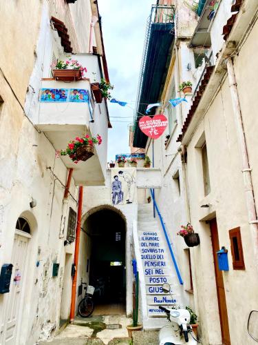 an alley with a stop sign in the middle at Il Riccio Apartment 28 in Procida