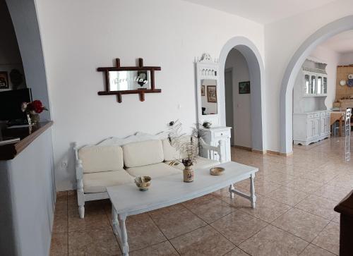 a living room with a white couch and a table at Elia in Skala