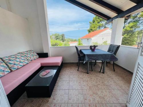 a patio with a couch and a table on a balcony at Apartment Bagaric in Stari Grad