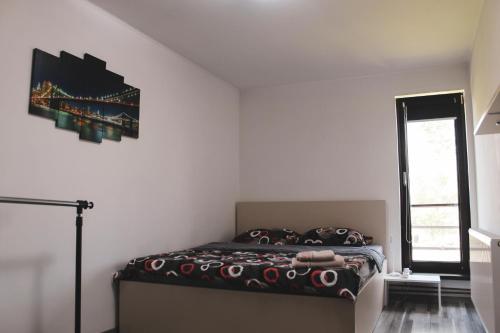 a bedroom with a bed in a white room at Spinning la Divici in Divici