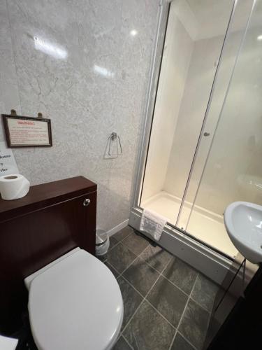 a bathroom with a shower and a toilet and a sink at Georgian House Hotel in Derby