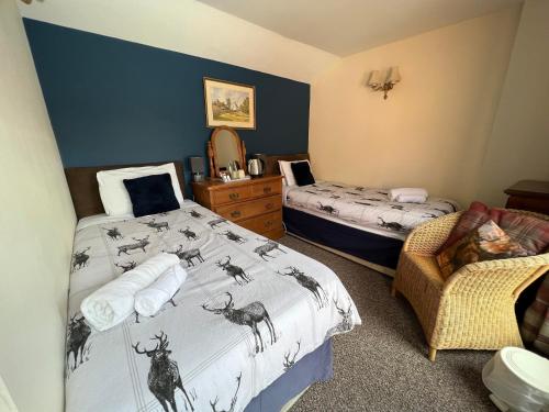 a bedroom with two beds with antlers on the sheets at Georgian House Hotel in Derby