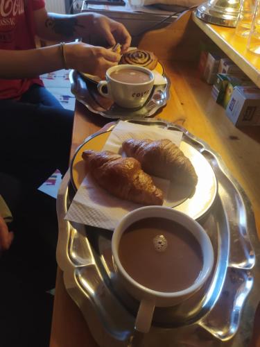 a table with a plate of food and a cup of coffee at Cuki Apartment in Budapest