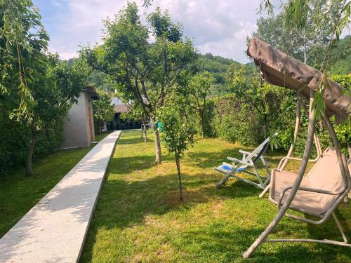 a hammock in the grass next to a path at Spinning la Divici in Divici