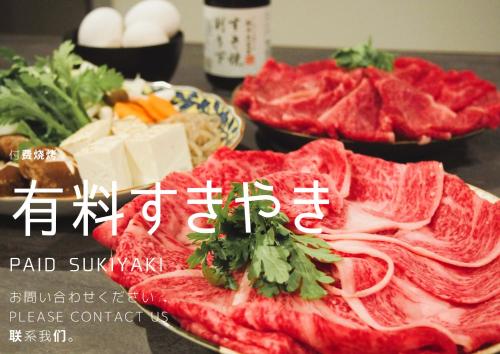 a plate of food with meat and vegetables on a table at サウナ・ジャグジー・完全貸し切りという贅沢　大人の秘密基地　Tiny Cabin TATEGU#02 in Miyota