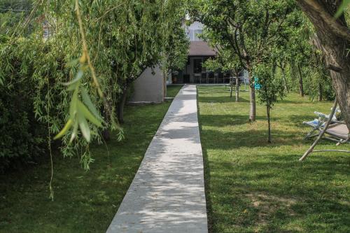 a walking path in a park with trees at Spinning la Divici in Divici