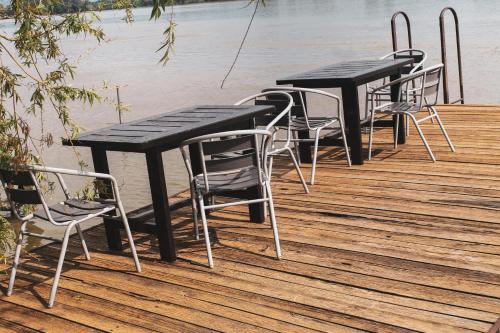 a row of tables and chairs on a dock at Spinning la Divici in Divici