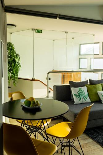a living room with a couch and a table and chairs at Blue Salinas in Aveiro