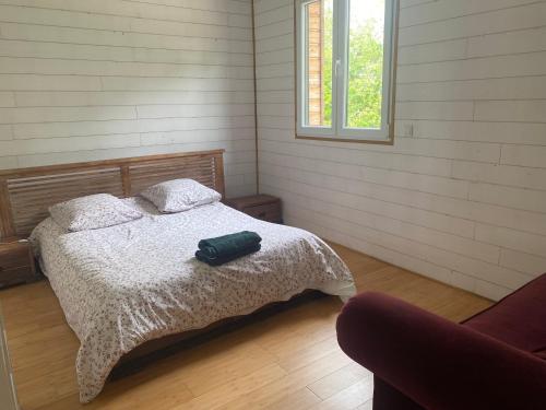a bedroom with a bed with a green bag on it at Domaine des Ecuries vailley in Bouleurs
