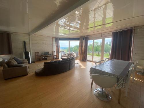 a large living room with a couch and a table at Domaine des Ecuries vailley in Bouleurs