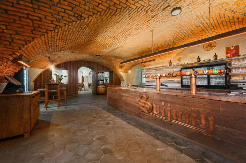 a restaurant with a wooden counter and a bar at Hotel Zámek Svijany in Svijany
